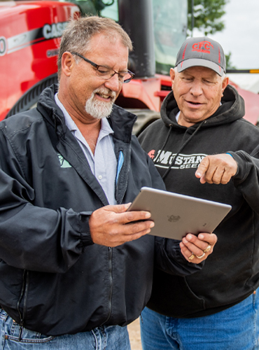 Farmer and banker looking at a tablet
