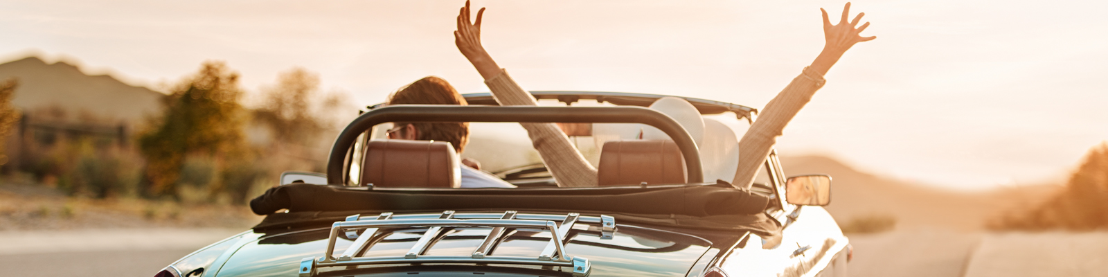 Couple riding in convertible car