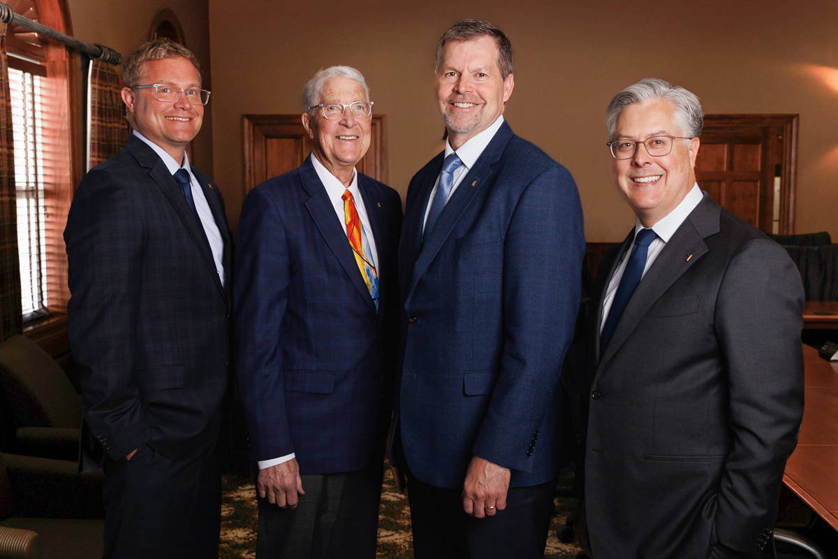 photo of four men in suits, Tom Fishback, Van Fishback, Kevin Tetzlaff, John Fishback