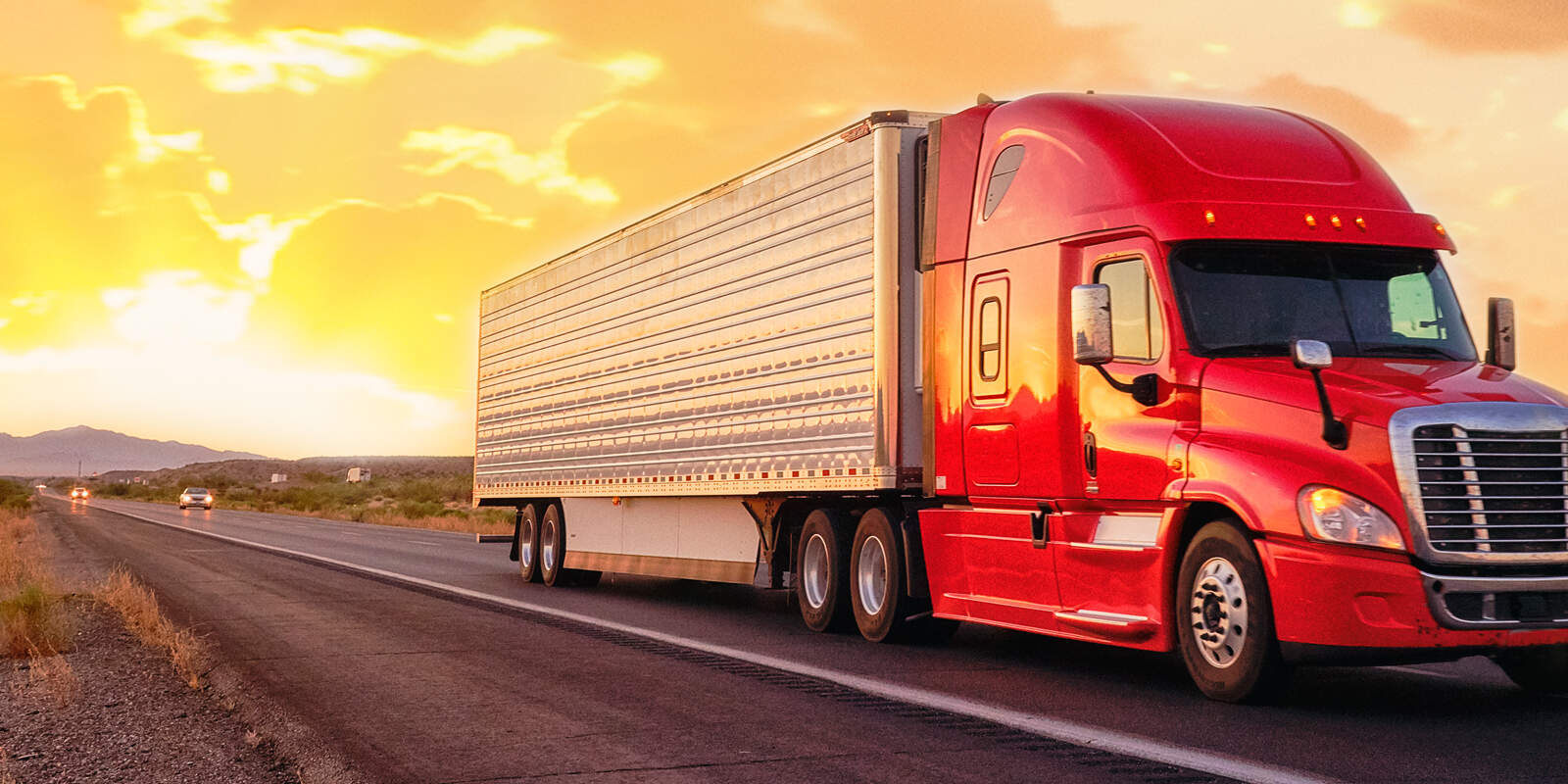 Semi truck driving down a highway.