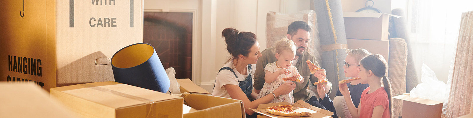 Family surrounded by moving boxes