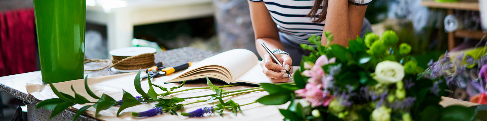 Florist writing notes in journal
