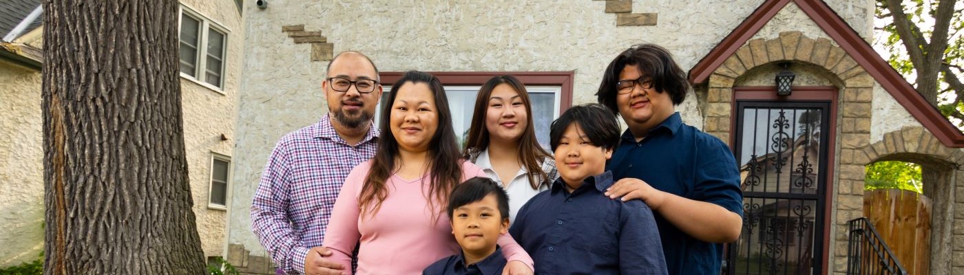 Family in front of house