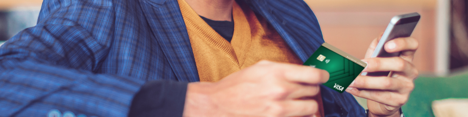 Man using credit card while on phone