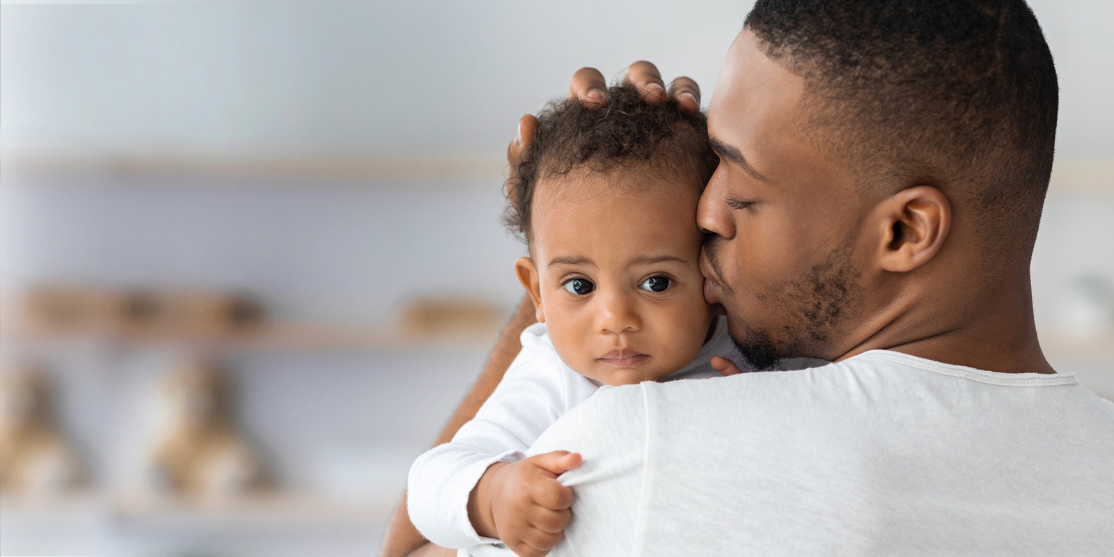 Man kissing his baby on the cheek