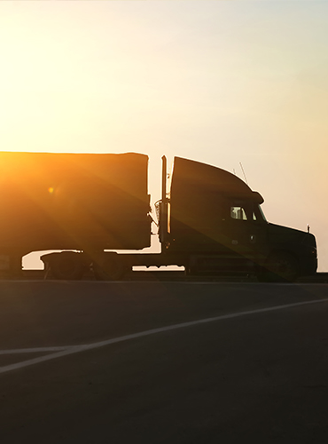 Semi truck driving down the road